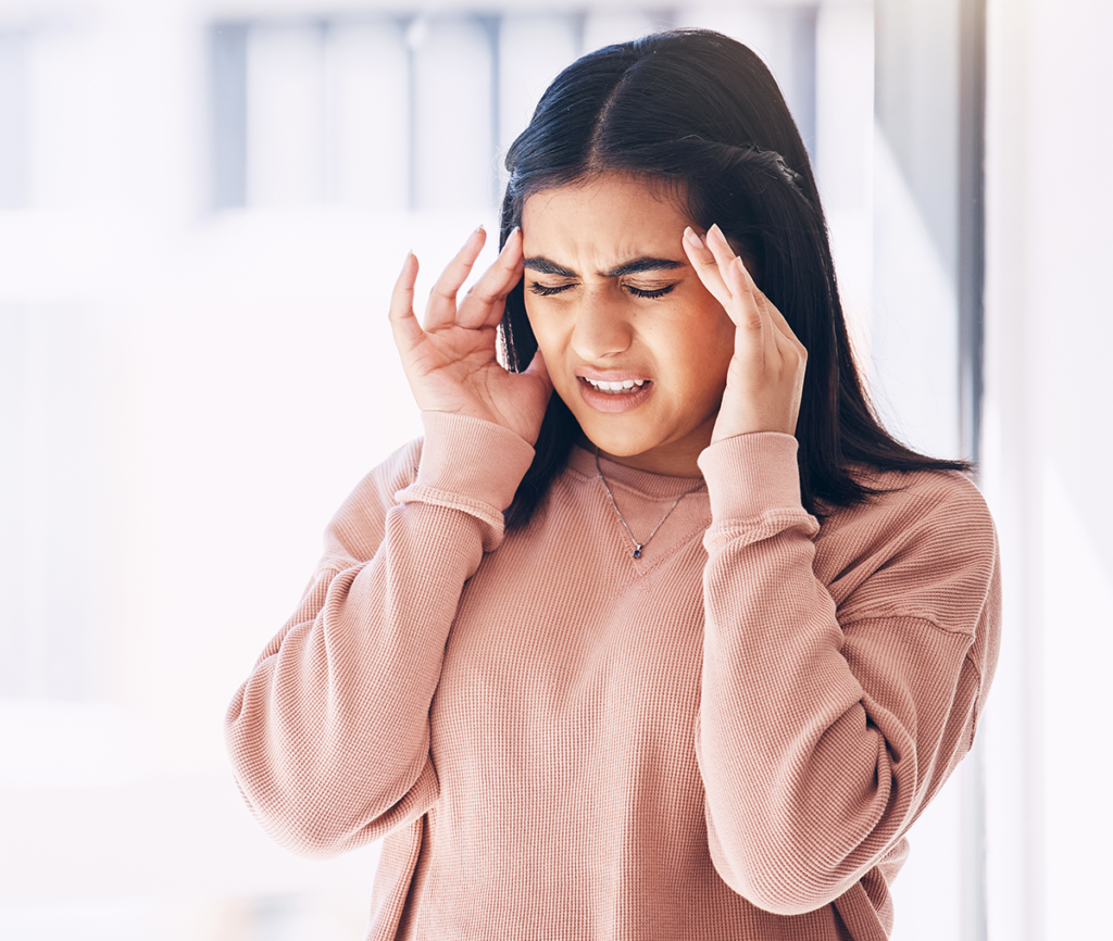Cancellation of Removal. Woman with her hands next to her head looking frustrated.