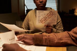 A couple sitting in their home reviewing past due bills.