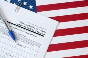 Blank Form I-589 application for asylum and withholding of removal placed on a United States flag