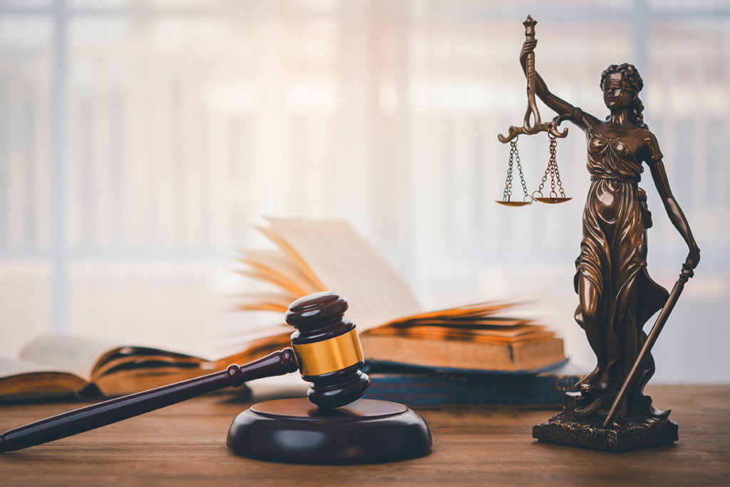 About us. statue holding law scales