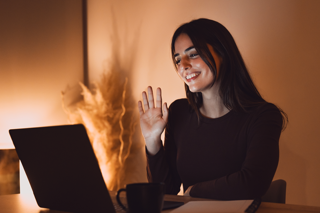 Violence Against Women Act. Woman looking at a laptop with her right hand raised.